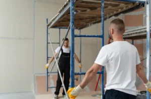 Workers assembling interior scaffolding for a renovation project using San Jose Scaffolding Rental services.