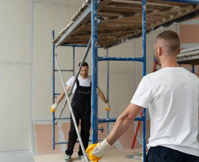 Workers assembling interior scaffolding for a renovation project using San Jose Scaffolding Rental services.